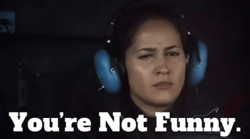 A Woman Wearing Headphones With The Words " You 'Re Not Funny " Below Her GIF