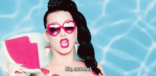 A Woman Wearing Heart Shaped Sunglasses Is Holding A Slice Of Watermelon And Saying Ha Not Me . GIF