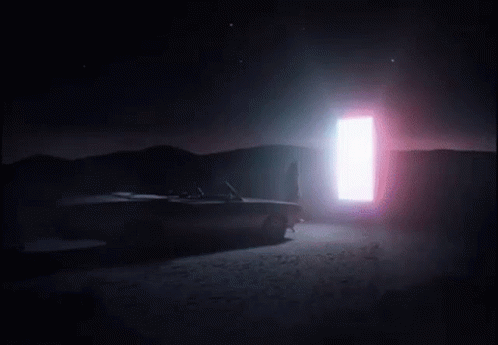 A Woman Wearing High Heels Is Walking On A Sidewalk In A Foggy Room . GIF