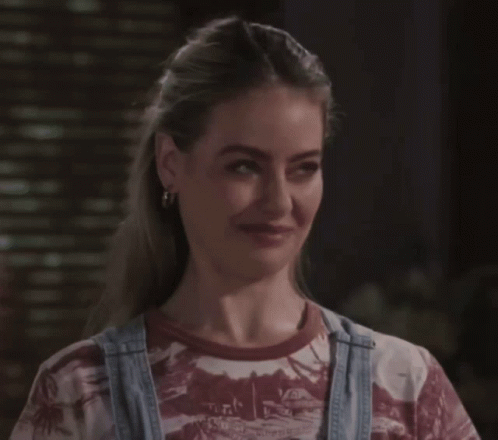 A Woman Wearing Overalls And A T-Shirt That Says Hawaii On It GIF