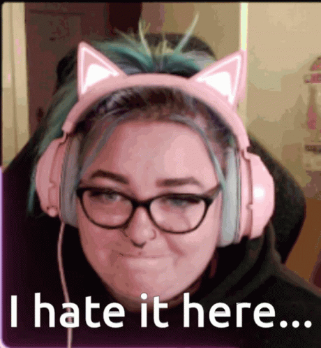 A Woman Wearing Pink Headphones With Cat Ears And Glasses Says I Hate It Here GIF