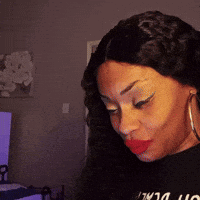 a woman wearing red lipstick and hoop earrings is wearing a black shirt that says ' i love you ' on it