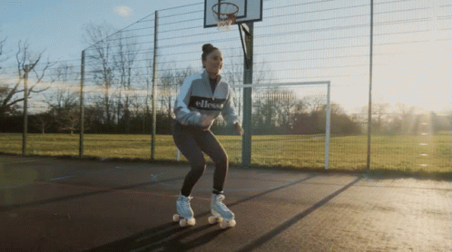 A Woman Wearing Roller Skates With The Word Ellesse On The Front GIF