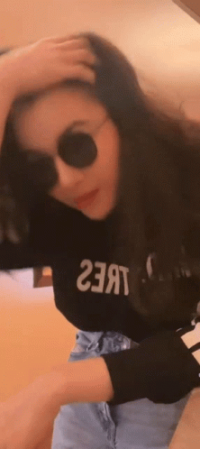 A Woman Wearing Sunglasses And A Black Shirt That Says ' 23 ' On It GIF
