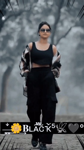 A Woman Wearing Sunglasses And A Black Tank Top Is Walking Down A Path With The Words Black 5 Written Below Her GIF
