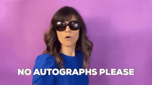 A Woman Wearing Sunglasses And A Blue Shirt Is Making A Funny Face And Saying `` No Autographs Please '' . GIF