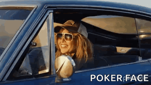 A Woman Wearing Sunglasses And A Hat Is Sitting In A Car With Poker Face Written On The Bottom GIF