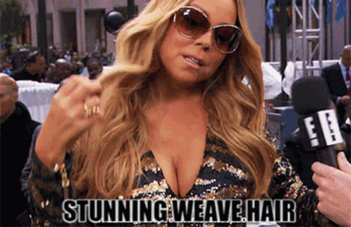A Woman Wearing Sunglasses And A Plunging Neckline Is Being Interviewed By A Reporter . GIF