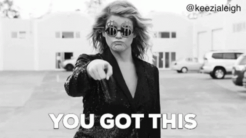 a woman wearing sunglasses and a suit is pointing at the camera and says `` you got this '' .
