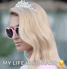 A Woman Wearing Sunglasses And A Tiara Is Saying `` My Life Is So Hard `` . GIF