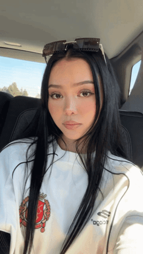 A Woman Wearing Sunglasses And A White Shirt That Says ' Ogood ' On It GIF
