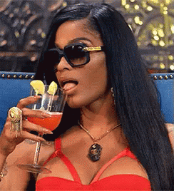 A Woman Wearing Sunglasses Is Drinking From A Wine Glass GIF