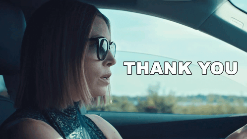A Woman Wearing Sunglasses Is Driving A Car With The Words Thank You Written On The Bottom GIF