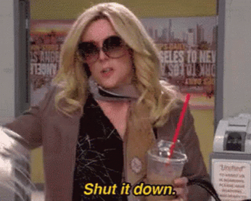A Woman Wearing Sunglasses Is Holding A Drink And Says Shut It Down GIF