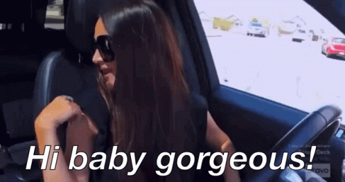A Woman Wearing Sunglasses Is Sitting In A Car With The Words Hi Baby Gorgeous Below Her GIF