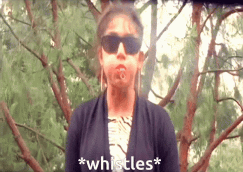 A Woman Wearing Sunglasses Says * Whistles * In Front Of Some Trees GIF