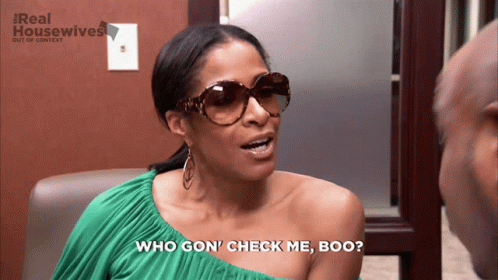 A Woman Wearing Sunglasses Says " Who Gon ' Check Me Boo " In Front Of A Real Housewives Logo GIF