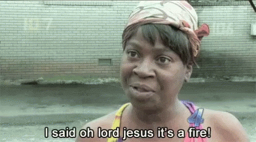 A Woman With A Bandana On Her Head Is Saying I Said Oh Lord Jesus It 'S A Fire ! GIF