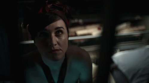 A Woman With A Bandana On Her Head Looks Up At Something GIF