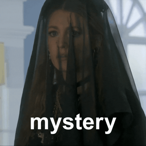 A Woman With A Black Veil On Her Head And The Word Mystery Below Her GIF