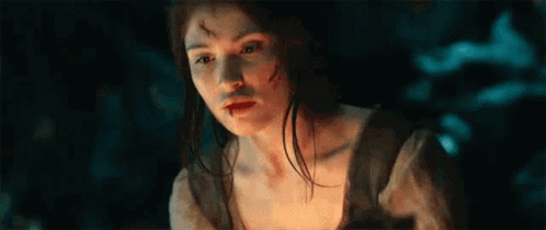 A Woman With A Bloody Face Is Holding A Torch In Her Hand . GIF