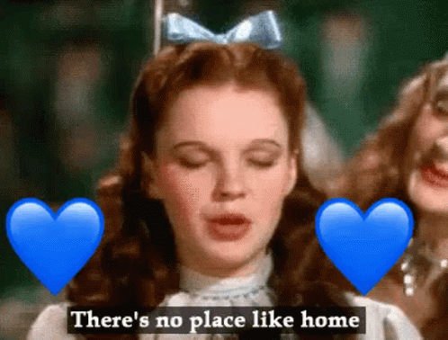 A Woman With A Blue Bow On Her Head Is Surrounded By Blue Hearts And The Words " There 'S No Place Like Home " GIF