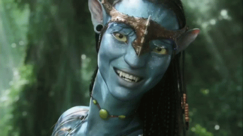 A Woman With A Blue Face And A Crown On Her Head Is Smiling GIF