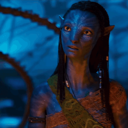 A Woman With A Blue Face And Braided Hair Is Wearing A Scarf GIF