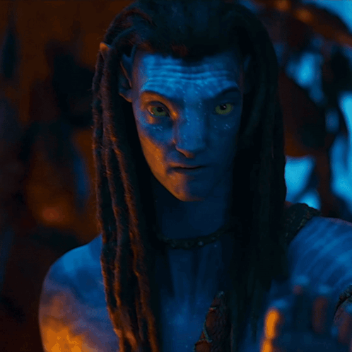 A Woman With A Blue Face And Braided Hair Is Wearing A Scarf That Says ' Snake ' On It GIF
