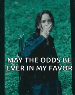 A Woman With A Bow And Arrow Is Covering Her Mouth With Her Hand And The Words May The Odds Be Ever In My Favor GIF