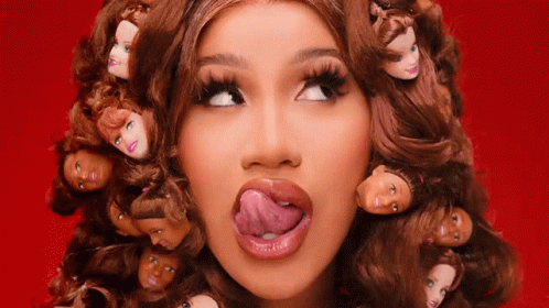 A Woman With A Bunch Of Barbie Doll Heads In Her Hair GIF