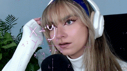 A Woman With A Cast On Her Hand Is Wearing Headphones GIF