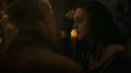 A Woman With A Choker Around Her Neck Is Looking At Another Woman GIF