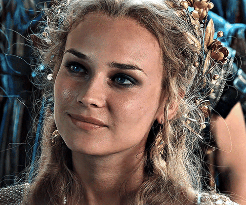 A Woman With A Crown On Her Head Looks At The Camera GIF