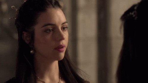 A Woman With A Crown On Her Head Looks To The Side GIF
