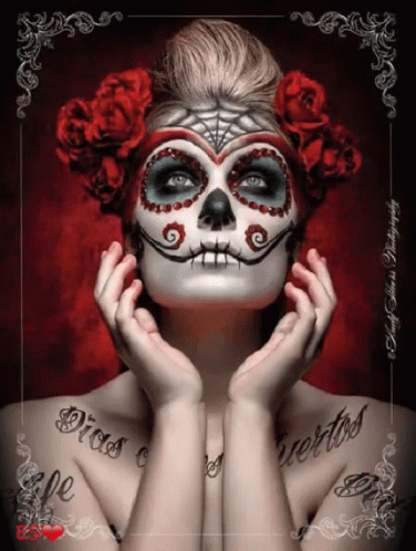 A Woman With A Day Of The Dead Face Paint And Roses In Her Hair GIF