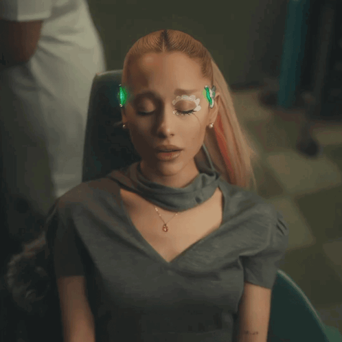 A Woman With A Green Light On Her Eyes GIF