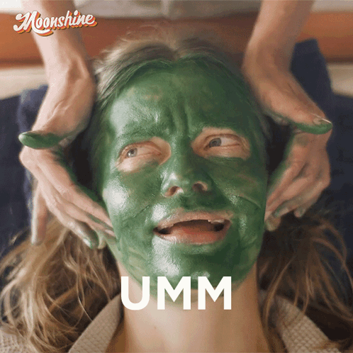 A Woman With A Green Mask On Her Face Has The Word Umm Above Her Face GIF