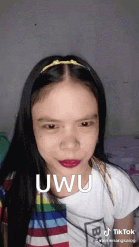 A Woman With A Headband On Her Head Is Making A Funny Face And Says Uwu . GIF