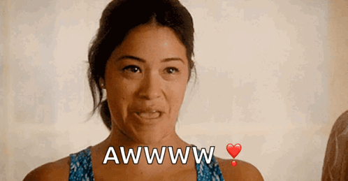 A Woman With A Heart And The Words Awwww On Her Chest GIF