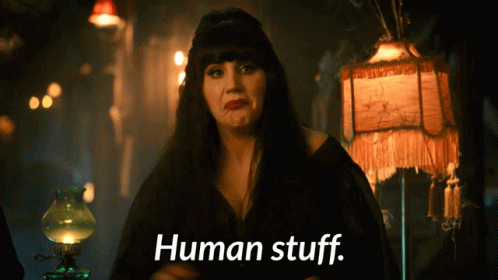 A Woman With A Lamp Behind Her Says " Human Stuff " GIF
