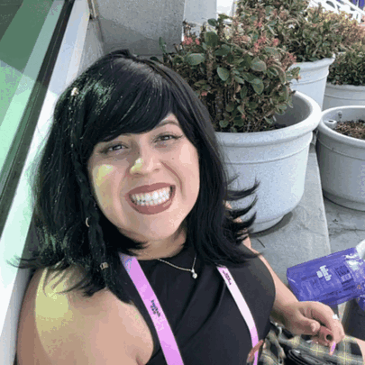 A Woman With A Lanyard Around Her Neck That Says ' Women 'S Alliance ' On It GIF