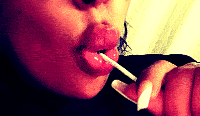 A Woman With A Lollipop In Her Mouth GIF