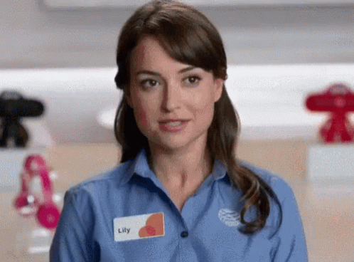 A Woman With A Name Tag That Says Lily GIF