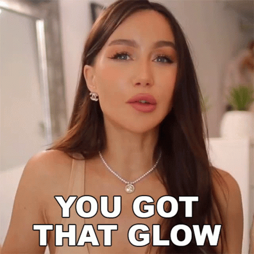 A Woman With A Necklace And Earrings Says You Got That Glow GIF