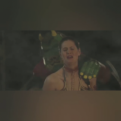 A Woman With A Necklace Around Her Neck Is Being Attacked By A Monster GIF