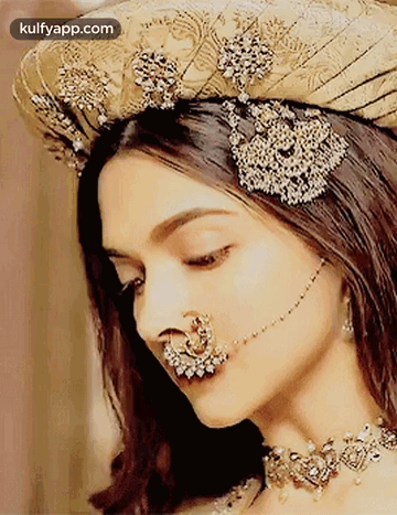 A Woman With A Nose Ring And A Hat On Her Head . GIF