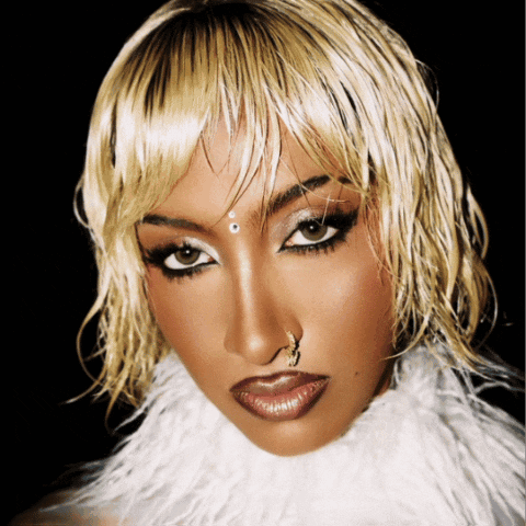 A Woman With A Nose Ring And A White Fur Collar GIF