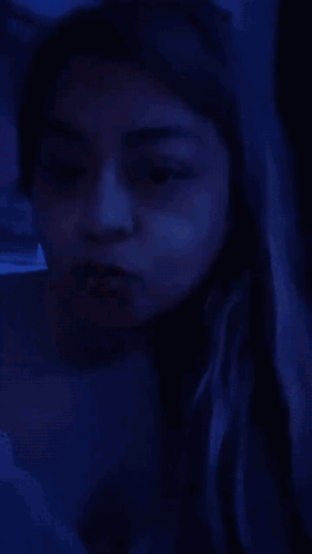 a woman with a nose ring is making a funny face .