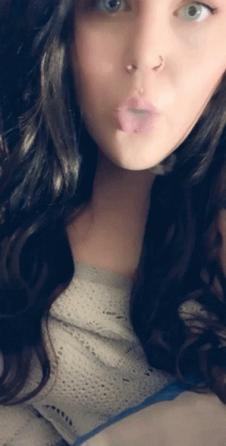 A Woman With A Nose Ring Is Making A Funny Face With Her Tongue Out GIF